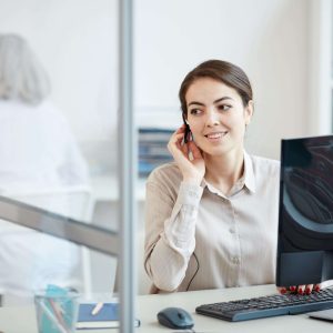 smiling-female-secretary-wearing-headset-at-workpl-2021-09-24-03-54-31-utc (1) (1)